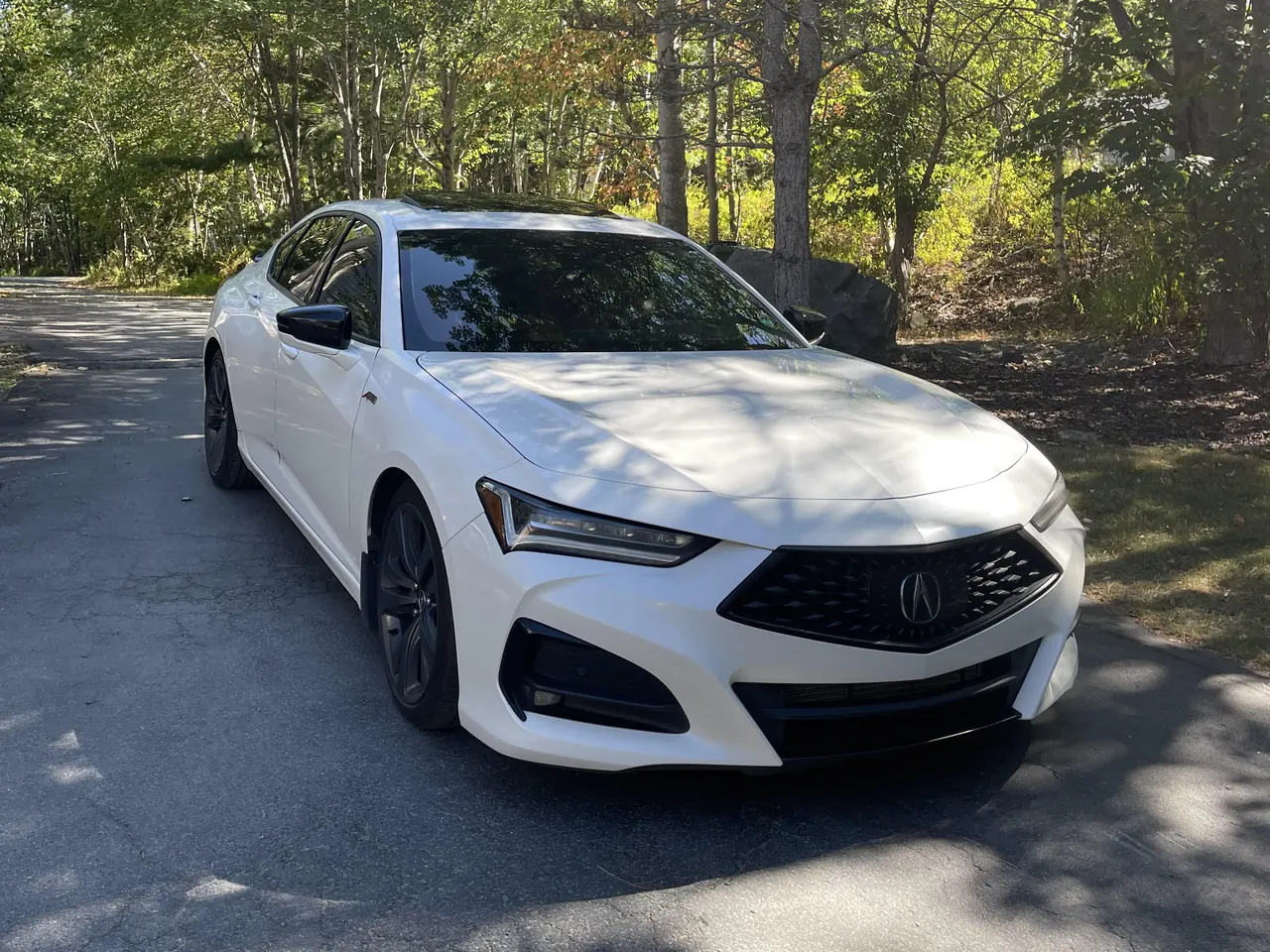 A white Acura TLX on a driveway