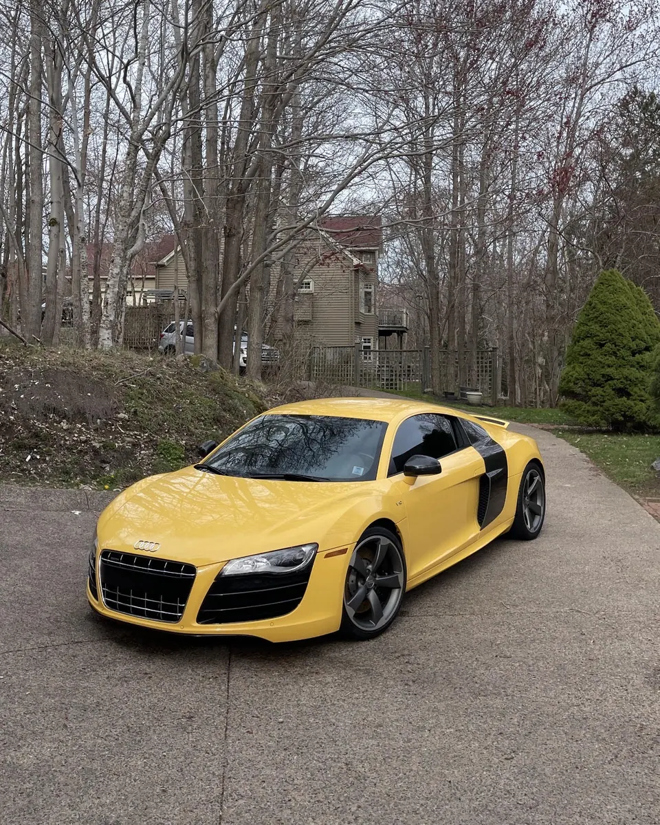A yellow Audi R8 on a driveway
