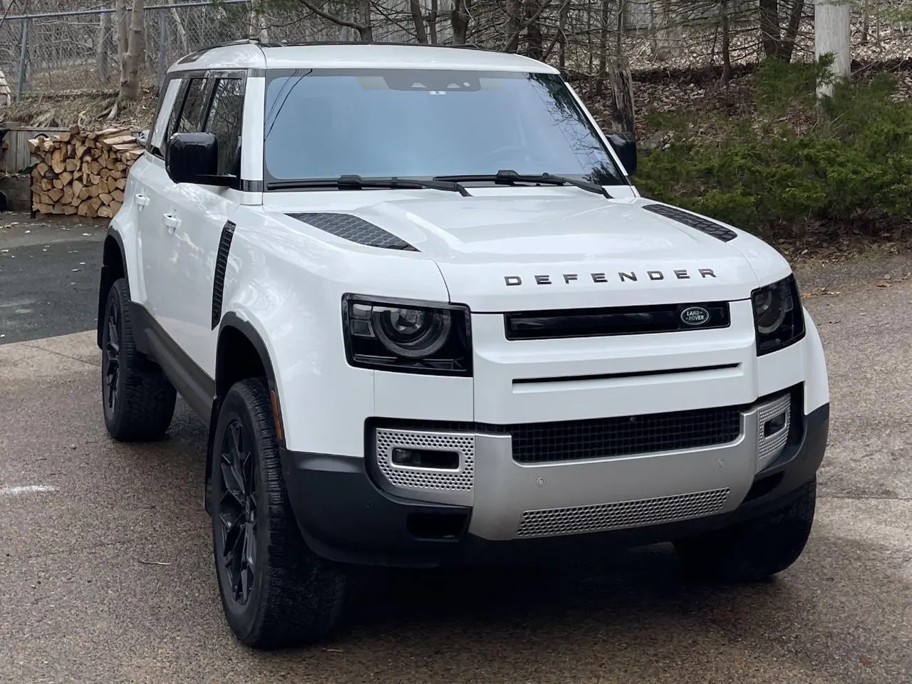A white Land Rover Defender on a driveway