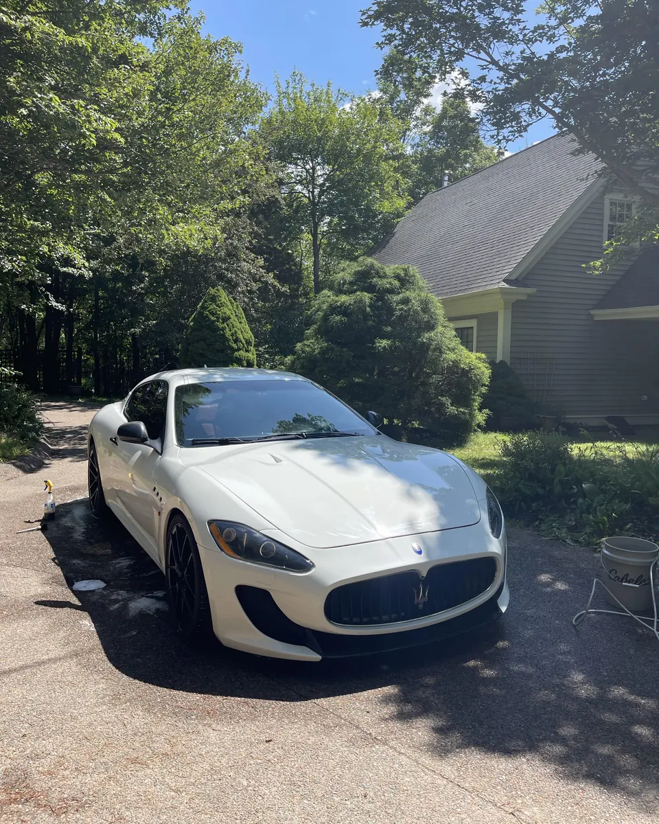 A white Maserati GranTurismo on a driveway